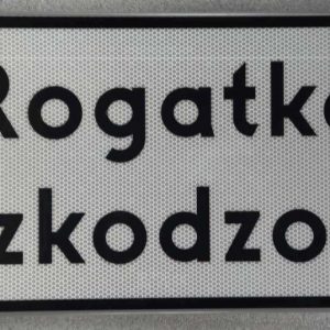 Tabliczka pod znak drogowy T z treścią "Rogatka uszkodzona".